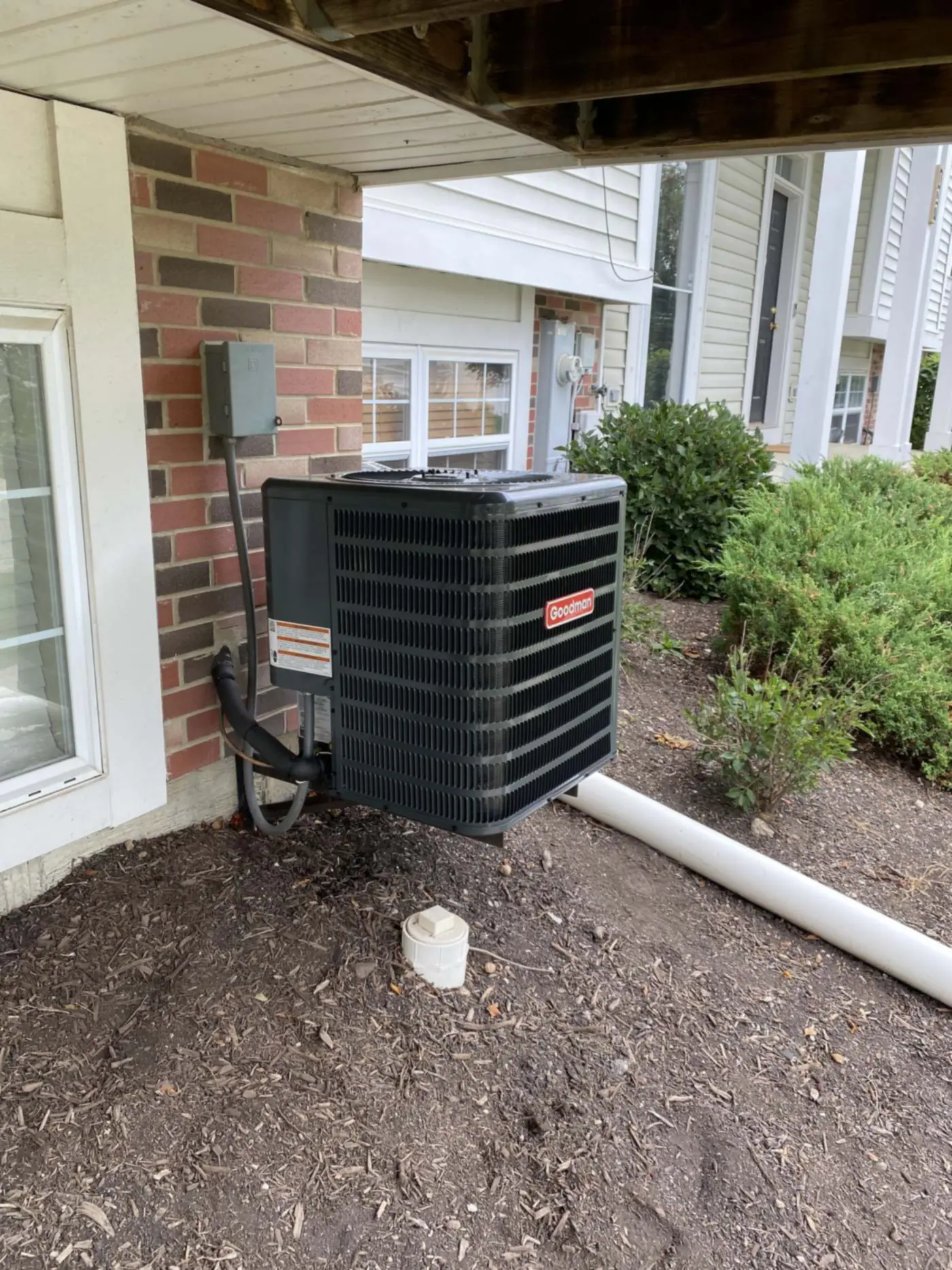 A new residential condenser installed beside a home